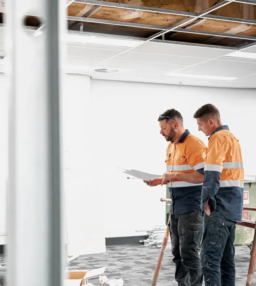 Construction workers viewing a commercial work site.