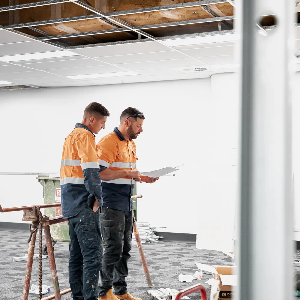 Construction workers viewing a commercial work site.